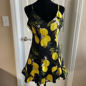 Lemon sundress with adjustable straps, cute ruffles and adorable pattern.